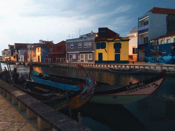 Boats in canal along buildings