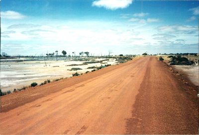 Empty road against cloudy sky