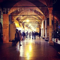 Full length of illuminated people in tunnel