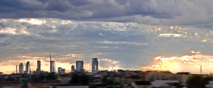 City skyline against cloudy sky