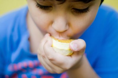 Close-up of boy eating fruit