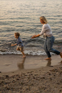 Children playing on sand at beach