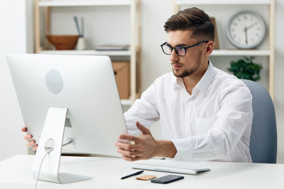 Young woman using laptop at office