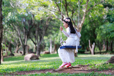 Woman standing by tree