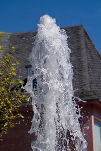 Close-up of water splashing against clear sky