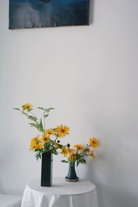 Flowers in vase on wall