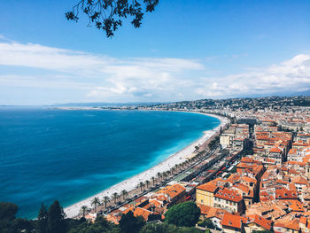 High angle view of townscape by sea against sky