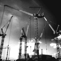 Low angle view of crane against sky