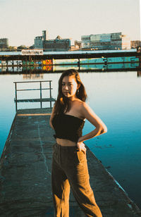 Side view of young woman standing at beach