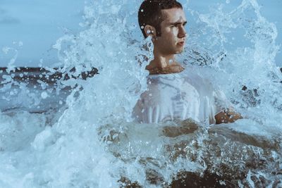 Portrait of shirtless man in swimming pool