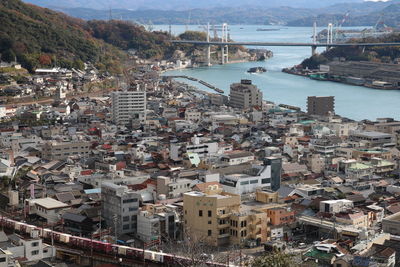 High angle view of townscape by sea