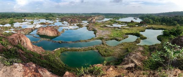 Scenic view of lake against cloudy sky