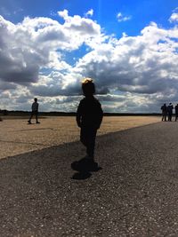 Man walking on sea shore