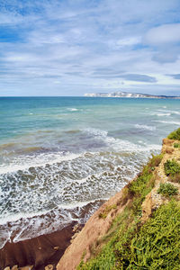 Scenic view of sea against cloudy sky