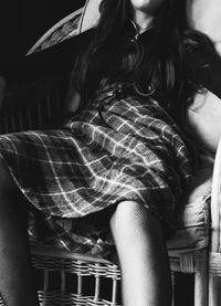 Midsection of woman sitting outdoors