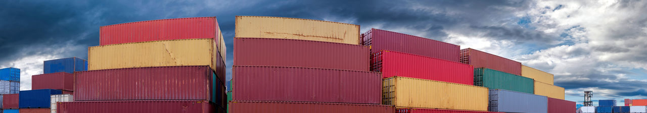 Low angle view of industrial building against cloudy sky