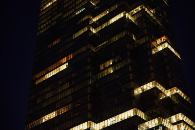 High rise office building with illuminated windows at night