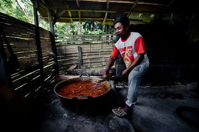 Side view of man working in kitchen