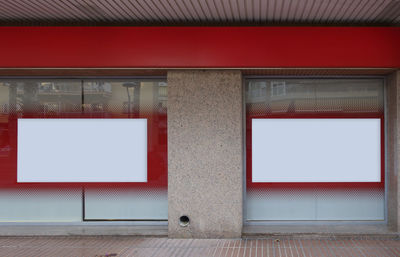 View of red door with graffiti on wall