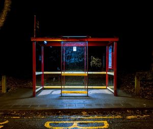 View of empty illuminated railroad station platform at night