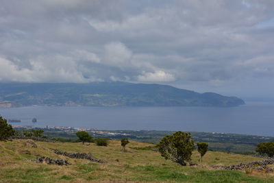 Scenic view of landscape and sea against sky