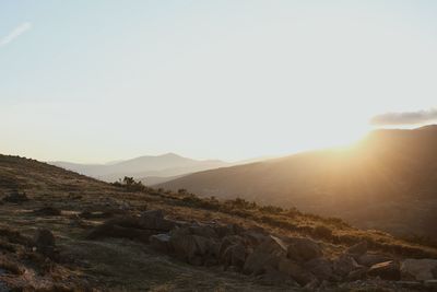 Scenic view of rocky mountains against sky during sunset