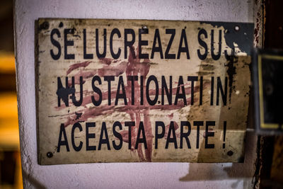 Close-up of information sign on wood