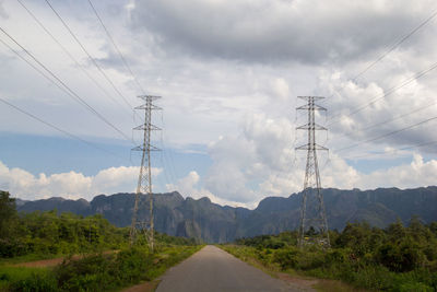 Road by mountains against sky