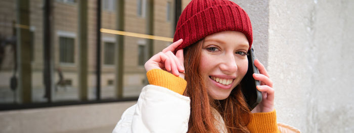 Portrait of young woman wearing hat