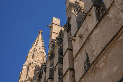 Low angle view of beautiful la seu cathedral against clear blue sky in summer