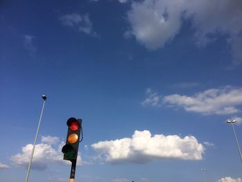 Low angle view of road sign against sky