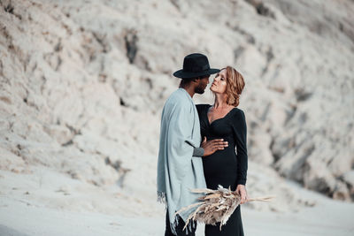 Couple embracing while standing at desert