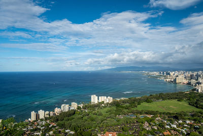 High angle view of townscape by sea against sky