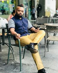 Full length of man sitting on chair