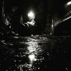 Reflection of illuminated buildings in puddle at night