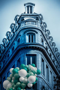 Low angle view of balloons against building