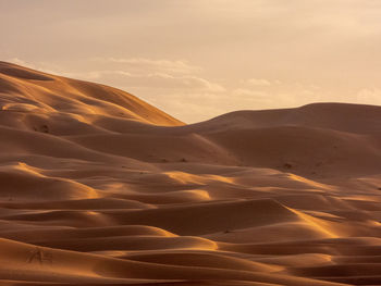 Scenic view of desert against sky during sunset