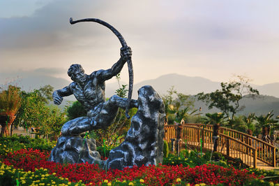 Statue against cloudy sky
