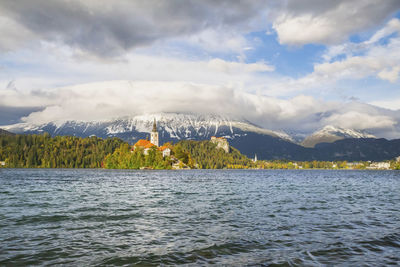 Scenic view of sea and mountains against sky