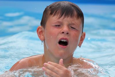 Close-up of boy looking at swimming pool