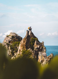 Rock formations by sea against sky