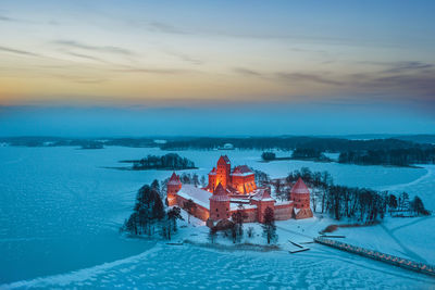 Scenic view of illuminated building against sky during winter