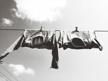 Low angle view of clothes drying on clothesline against sky