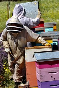 Low section of man standing on field bee keeping