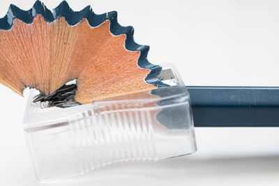Close-up of pencils on table against white background