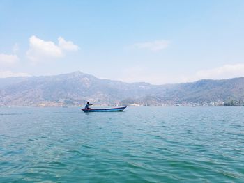 Side view of man on boat sailing in sea