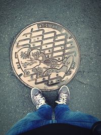 Low section of man standing on tiled floor