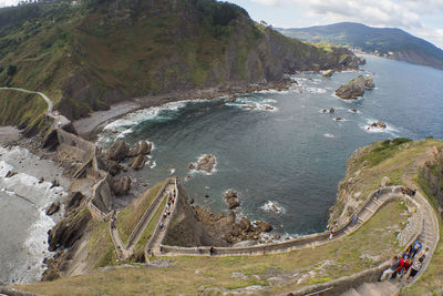 High angle view of land and sea against mountains in the spanish island of gaztelugatxe