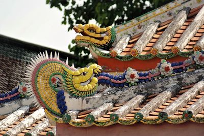 Low angle view of statue against temple