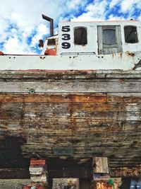 Low angle view of rusty car against sky